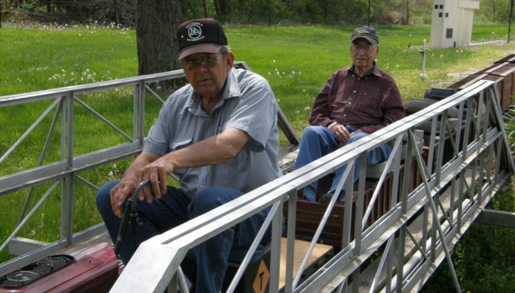 Pat and HK riding across a truss bridge